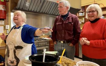Morris Farm President Madelyn Hennessey gets the crowd chuckling as she encourages donations. Also pictured are Les and Merry Fossel. SUSAN JOHNS/Wiscasset Newspaper