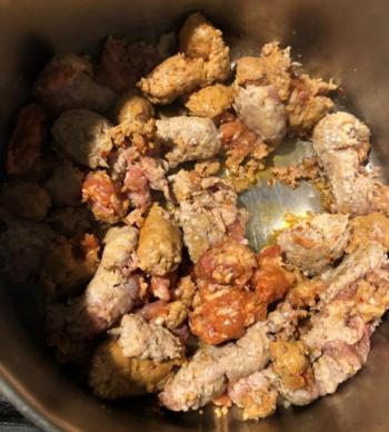 Cooking the hot and sweet sausage. Lisa Orne Hallinan photo