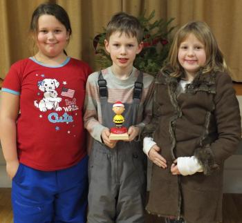 Edgecomb Eddy School students from left, Katy Pray, John Cooper and Gabby Main accept the We Love Edgecomb Award for Sarah Currier’s room in the Charlie Brown Christmas Tree Decorating Competition. BILL PEARSON/Boothbay Register