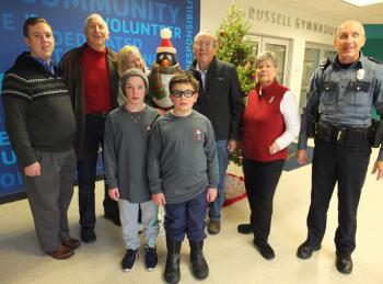 2019 Penguin Plunge honorary volunteers Ted and Betty Repa passed the ‘torch’ to this year’s selection Dave and Mary Patch Dec. 11 at BRYMCA. Pictured from left, front, Hannah Hills and Byran Hills; back, Y aquatics instructor Daniel Parrot, Ted Repa, Betty Repa, Dave Patch, Mary Patch and Boothbay Harbor police patrolman Larry Brown. BILL PEARSON/Boothbay Register