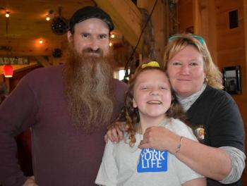 Emcee Darrell Gudroe, fundraiser founder Suzie Edwards, and Brady’s owner Jen Mitchell are all smiles at the very successful Fill the Boat With Love event at Brady’s Dec. 29. LISA KRISTOFF/Boothbay Register