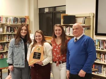 Mark Bridgham, president of Central Maine Basketball Board #20, presents the Board’s sportsmanship award to the BRHS girls basketball team, represented here by team seniors, from left, Josey Smith, Madison Faulkingham and Chloe Arsenault. Courtesy of Brian Blethen