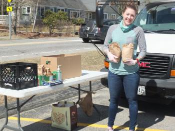 BRYMCA Development and Project Coordinator Stephanie Tucker, seen here without her usual mask, is responsible for distributing bag lunches each weekend as part of a community nutrition program. The coronavirus resulted in the Community School District and Y joining forces in providing weekend meals to local students. BILL PEARSON/Boothbay Register