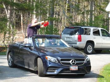 Jim Singer, with Becky Singer driving, celebrates John Druce’s birthday. BILL PEARSON/Boothbay Register