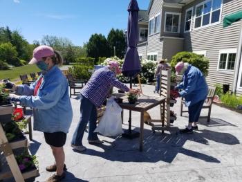 BRGC garden therapy team enjoys the sunshine while filling vertical planters outside the Gregory Wing with annuals and veggies. Courtesy photo