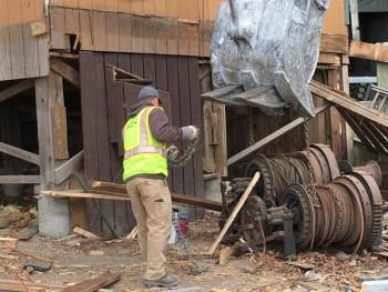 Workers find one of the giant winches that used to pull ships up onto shore. Courtesy of Bob McKay