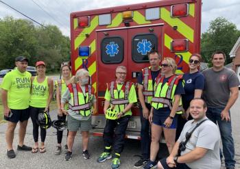 From left, Firefighter Five Foundation founder Steve Bender, fellow Pennsylvanian Lisa Steiner, Woolwich junior firefighter Hailey Namer, Woolwich Selectman Allison Hepler, Woolwich firefighter/EMT Danny Evarts, Woolwich Fire Lt. Donny Munsey, the department’s safety officer Jennifer Coombs Munsey, EMT Morgan Kindelan, firefighter Andrew Moskevitz and, in front, firefighter-EMT Rob Nibarger pose before the Wiscasset-Woolwich leg of Run2Respond Aug. 16. SUSAN JOHNS/Wiscasset Newspaper