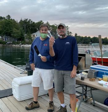 Linekin Bay Resort owners/grill masters Scott Larson, left, and Steve Malcom cooked up picnic fare for the outdoor film event. Erin Stodder photo