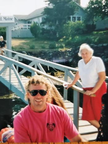 Bennie Alice Moore, on the gangway, and son Bob, on the dock, wait to greet the next group of visitors and lobster bake lovers at Cabbage Island. Courtesy of Ginny Moore Murray