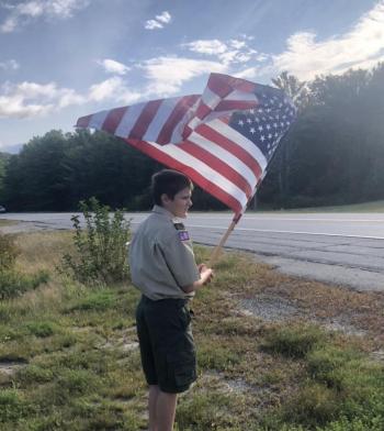 Boy Scout Jeffrey Ford flies the American flag in remembrance of 9/11. Robin Ford photo