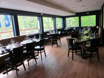 Interior dining with large picture windows frame the walls of the restaurant. Photo by Kay Stephens