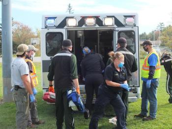 Boothbay Region Ambulance Service crew members prepare an injured landscaper Oct. 6 for transport by Lifeflight of Maine to Maine Medical Center. BILL PEARSON/Boothbay Register