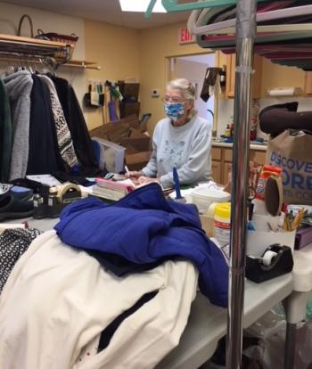 Betty Goulette hard at work sorting donations in the back room of the Thrift Shop. Courtesy of Laura Zajdel