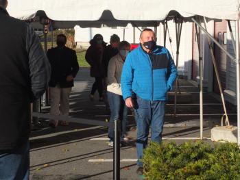 Boothbay Harbor residents brave a strong early morning wind on Election Day as they waited outside the polls before casting ballots. BILL PEARSON/Boothbay Register
