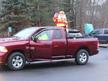 Sparky rides in Boothbay Fire Chief Dick Spofford’s truck in the first Lighted Fire Truck Parade Nov. 28. BILL PEARSON/Boothbay Register