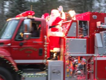 Santa Claus and Mrs. Claus wore their traditional Christmas suits and not so traditional surgical masks while riding in the Boothbay No. 2 tanker in the parade. BILL PEARSON/Boothbay Register