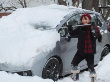 Boothbay Harbor resident Sue Decker brushes off her car Dec. 18 after a winter storm dropped seven inches of snow. BILL PEARSON/Boothbay Register