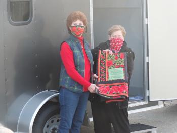 Anne Burt won the American Legion Quilt Raffle drawing held on Veterans Day and received her prize from quilter Sara Fahnley on New Year’s Day. BILL PEARSON/Boothbay Register