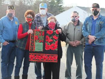 American Legion Post 36 sold 220 raffle tickets for a quilt to raise funds for VETS Inc. which provides temporary homeless shelters for Maine veterans. On Jan. 1, quilt maker Sara Fahnley, front, right, presented raffle winner Anne Burt, front left, her prize. VETS. Inc. members, back, Ed Harmon, second left, Arthur Richardson, back, second right, and John Hargreaves, back right. Also pictured, Post Cmdr. Dave Patch. BILL PEARSON/Boothbay Register