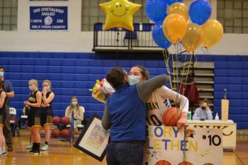 Glory Blethen receives a hug Feb. 15 from mother Lesley Blethen after becoming the sixth Lady Seahawk to score her 1,000th career point. BILL PEARSON/Boothbay Register
