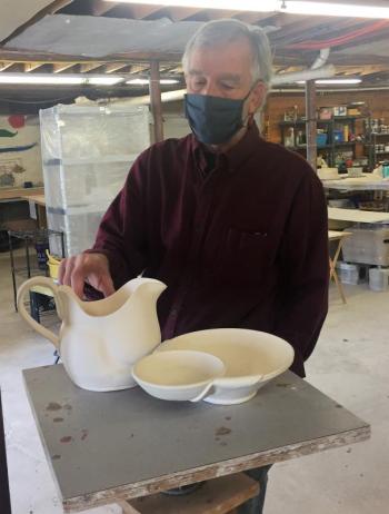 Clark Griffith shows his current project, a pitcher with matching tiered serving dish. LISA KRISTOFF/Boothbay Register BIll Clark