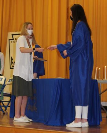 Emily Echols receives her National Honor Society certificate and pin from member Glory Blethen during the induction ceremony March 31. Paulette Carter photo