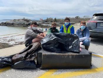 Southport kids clean the beach for the Southport Island Cleanup Day. From left are Rath Schoenthal, Otto Schoenthal, Graham Harris and Spencer Pottle. The boys found tires, a partial dock float and other debris at Hendricks Head. Courtesy of Medea Harris