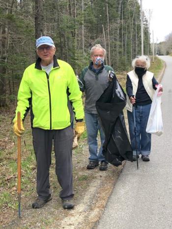 Joe Maziarz, Doug Jones and Isabel Maziarz start to fill bags on Cross Road. JENNY BENNETT/Boothbay Register