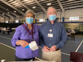 Vanda Yong and John Hochstein volunteering their time at the LincolnHealth Boothbay Y Vaccination Center. Courtesy of St. Andrews Auxiliary