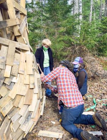 Coastal Maine Botanical Gardens volunteer Louise Cowan assists horticulturist Jenn Dunlap and a member of artist Thomas Dambo’s crew in preparing a new experience planned for this month. Courtesy photo