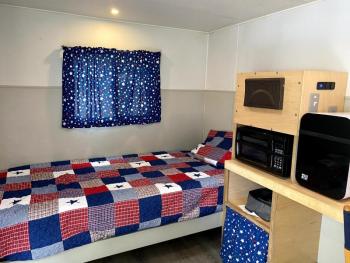 The interior of a V.E.T.S trailer. Each shelter comes with a bed, microwave, refrigerator, commode and heater. ISABELLE CURTIS/Boothbay Register