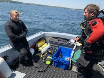 OceansWide divers Elizabeth Foretek and Matt Louis discuss a dive for ghost lobsters traps in Boothbay Harbor. BILL PEARSON/Boothbay Register