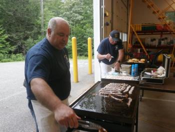 John Potter fries the bacon. ART MAYERS/Boothbay Register