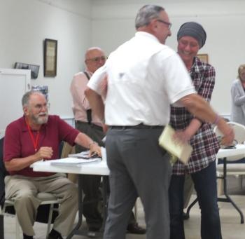 Boothbay Harbor Selectman Tricia Warren receives a congratulatory hug July 28 from former Gov. Paul LePage as she announced her candidacy for the state legislature. BILL PEARSON/Boothbay Register