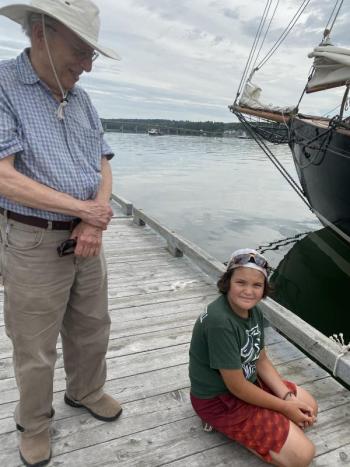 Wiscasset’s Marty Fox and grandson Asa Burchstead, 8, watch the schooners enter Wiscasset harbor Aug. 19. SUSAN JOHNS/Wiscasset Newspaper