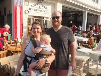 In Adam Climo’s 31 years, he has attended the annual Southport Firemen’s Auction every time. This year, he brought wife Eden and 11-month-old son Griffin. BILL PEARSON/Boothbay Register