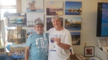 Ed Brown hands a $250 check to Boothbay Region Health Center board member John Webster. Courtesy photo