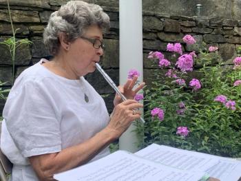 Newcastle’s Nancy Parker plays a whistle in the Sunken Garden off Federal Street Aug. 18. SUSAN JOHNS/Wiscasset Newspaper