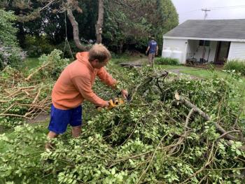 Rebuilding Together volunteer Andrew House lends a hand clearing brush Sept. 25 during an Ocean Point Road project. BILL PEARSON/Boothbay Register