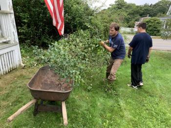 Rebuilding Together volunteer Nate House, left, and Lewis House remove brush Sept. 25 during a project. BILL PEARSON/Boothbay Register