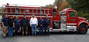 Chief Richard Spofford, fifth from left, and members of Boothbay Fire Department wait to greet BRES students. JANE CARPENTER/Boothbay Register