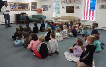 The chief explains fire safety and demonstrates a smoke alarm. JANE CARPENTER/Boothbay Register