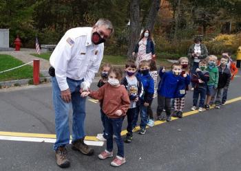 A special hug for Chief Richard Spofford from his granddaughter, Bristol, who is in the BRES pre-kindergarten class. JANE CARPENTER/Boothbay Register