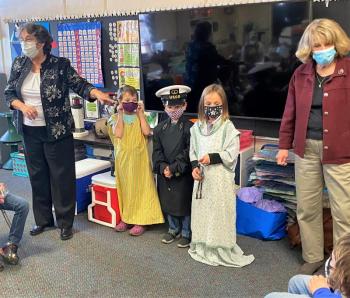 Elaine Jones, far left, and Jean McKay, visiting with first graders at Boothbay Region Elementary School, brought costumes and props used in the Living History program. Courtesy of Elaine Jones