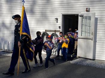 Americanism Officer Chris Armstead leads Boy Scout Troop 213 in a procession to dispose of retired American flags by burning. JOSEPH CHARPENTIER/Boothbay Register