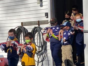 Boy Scout Troop 213 in a procession to dispose of retired American flags by burning at the Nov. 11 ceremony at American Legon Post 36 in Boothbay. JOSEPH CHARPENTIER/Boothbay Register