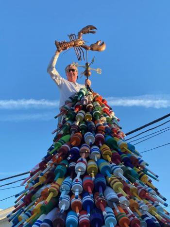 Tom Minerich installs the lobster weathervane. Courtesy photo