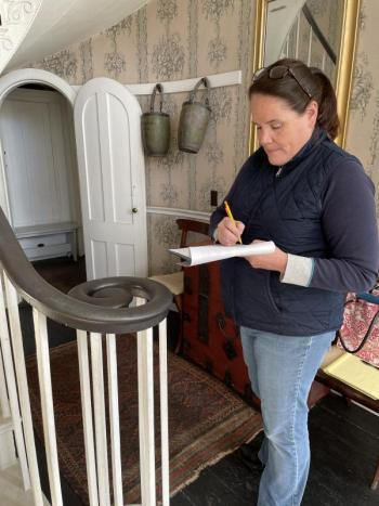 In the Nickels-Sortwell House front hall, floral designer Laura Tibbetts makes detailed notes for the seasonal displays she’ll create for tours during Wiscasset Holiday Marketfest. Marketfest photo