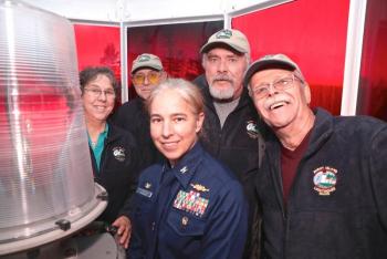 In the lantern room of Burnt island Lighthouse on the 200th anniversary, keepers Elaine Jones, Henry Sieg; Paul Kelly and Randy Griffing with USCG Capt. Amy Florentino. Robert Mitchell photo