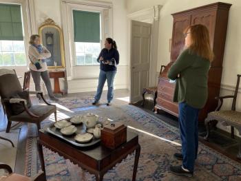 From left, historical consultant Lisa Welter, floral designer Laura Tibbetts and Nickels-Sortwell house manager Peggy Konitzky discuss the history and furnishings of the house as Tibbetts prepares to decorate the house in holiday greens for tours during Wiscasset Holiday Marketfest, Dec. 3-5. Marketfest photo